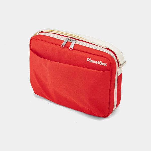 Red travel bag with white zipper and 'PlanetBox' branding on a light gray background