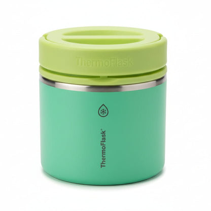 Green thermos with a lid on a white surface

